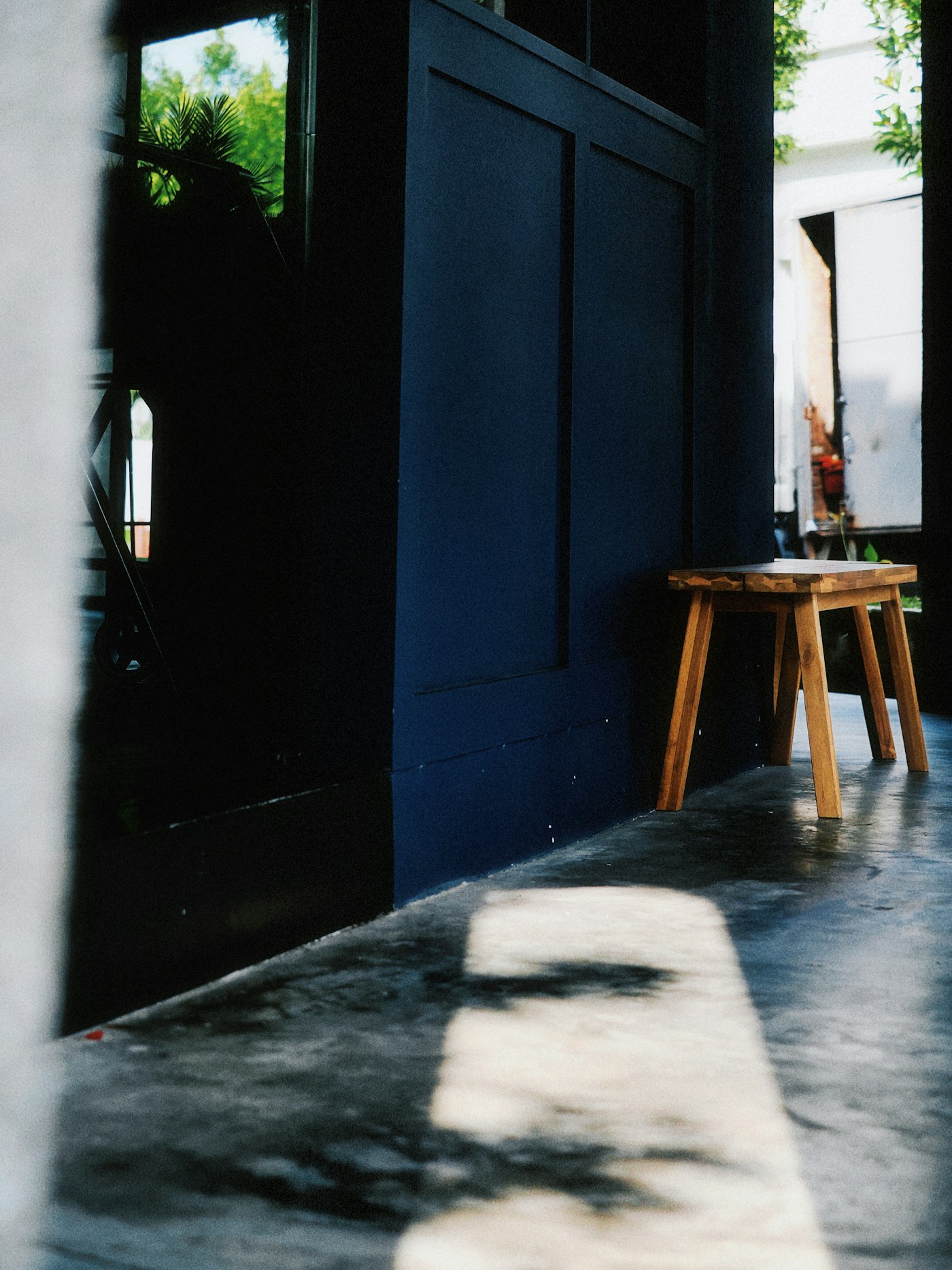 Tabouret en bois dans un intérieur bleu profond